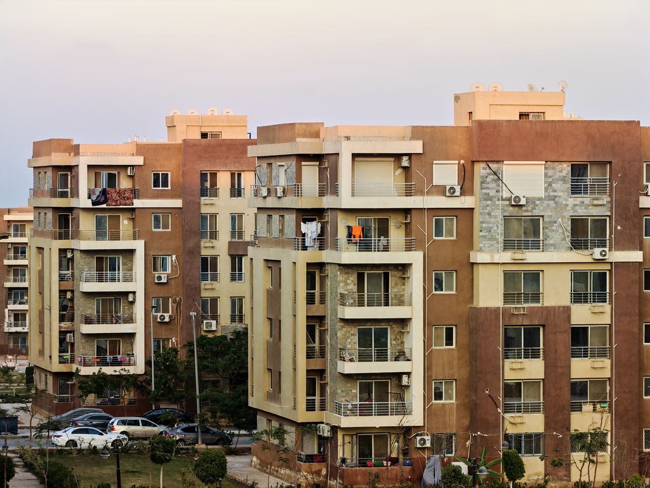 Urban residential buildings with balconies and air conditioning units.